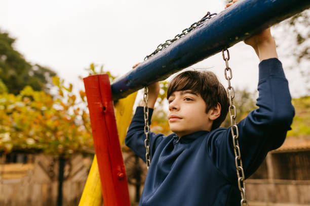 istock Contemplative pre teen boy on playground 1556911087