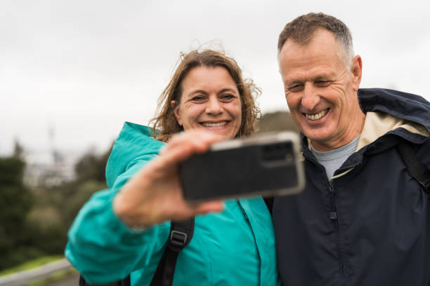 istock Senior travelers using smart phone outdoor. 1556945680