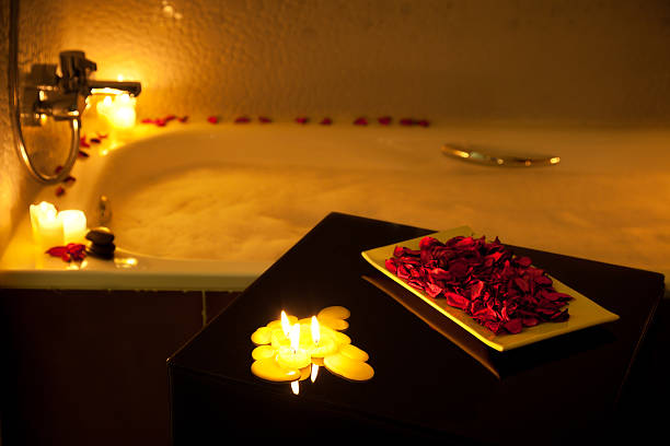 Romantic bubble bath Romantic bathtub ready with candlelight and red petals.  Multiexposure using only candlelight. CANON EOS 5D MarkII free standing bath photos stock pictures, royalty-free photos & images