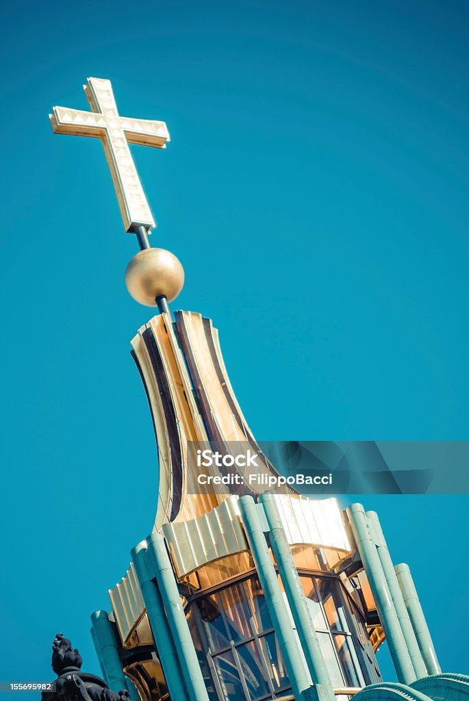 Golden cross - vintage style A golden cross against clear blue sky. Elaborated image for the vintage mood. Added some grain. Religion and spirituality concept. The cross is on the Berliner Dome. Berlin Stock Photo