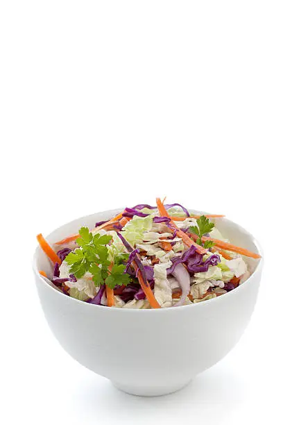 Cabbage salad with carrots, in white bowl