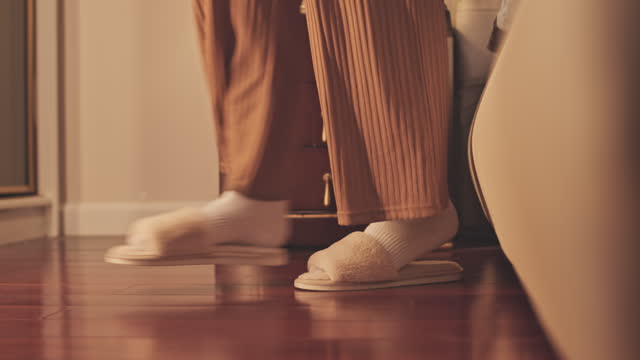 Unrecognizable Woman Wearing Slippers Getting Up Out of Bed