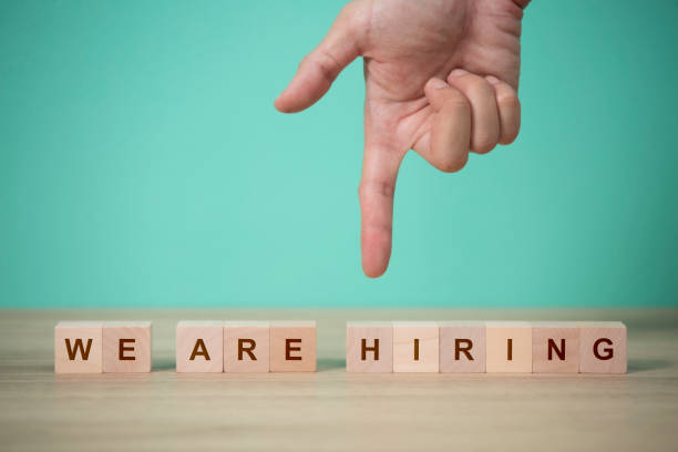 istock Job recruiting advertisement. represented by 'WE ARE HIRING' texts on the block. 1556983328