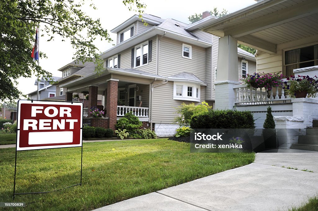 A beautiful home available for rent Home For Rent Sign in Front of Beautiful American Home  House Rental Stock Photo