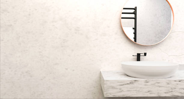 istock Modern loft white marble and concrete vanity counter, ceramic sink, circular mirror, black steel towel rack, and concrete wall. Fund for the exhibition of bath and body hygiene products. 1557026234