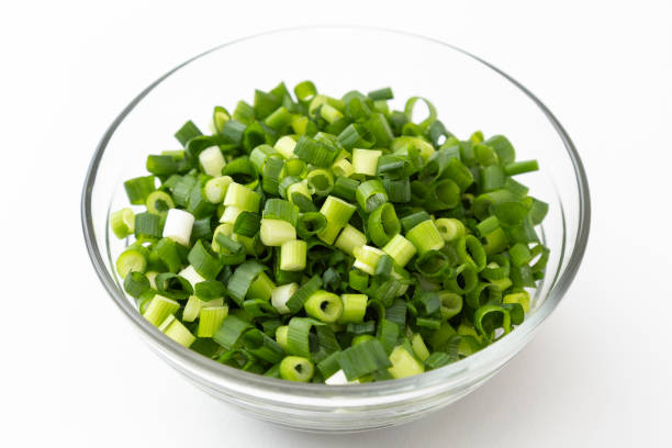 istock Chopped green onions on a white background. 1557044602