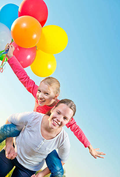 istock Girl playing outside with balloons 155705320