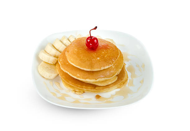 pancakes with banana sliced and cherry in dish isolated on white background ,include clipping path