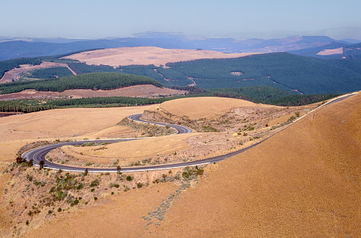 Roadway passing through rocky landscape in a sunny day, at the highlands of Serra da Estrela. The highest mountain range in continental Portugal.