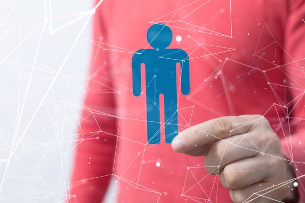 istock Man holding a blue person icon with white interconnected lines around it 1557136778