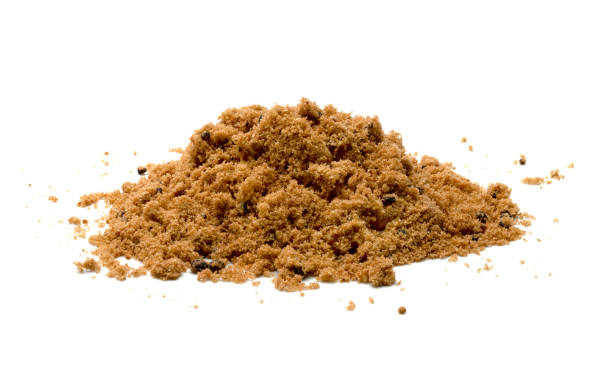 istock Brown cane sugar pile isolated on white background 1557141668