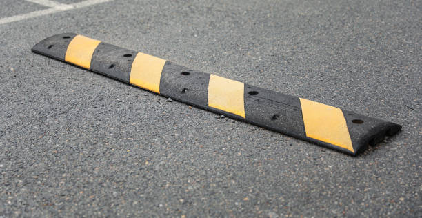 istock speed bump on a street symbolizes traffic control, caution, and slowing down for safety. It represents the need to be vigilant and considerate of others 1557176323