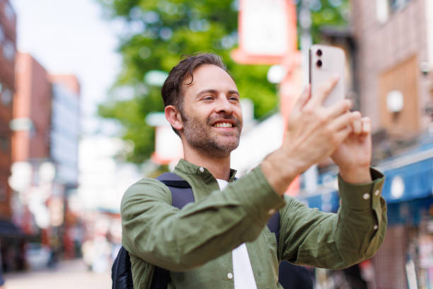 istock Caucasian man taking picture with mobile phone 1557207998