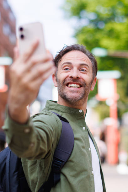 istock Caucasian man taking selfie with mobile phone 1557208006