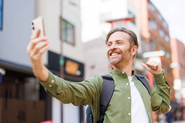istock Caucasian man taking selfie with mobile phone 1557208010