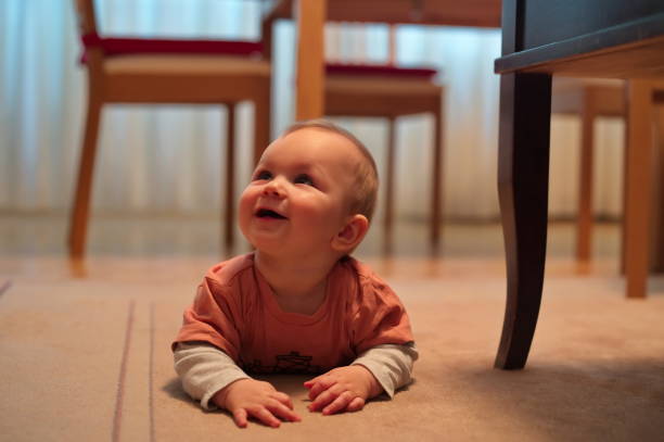 istock Baby boy crawling on the floor 1557213501