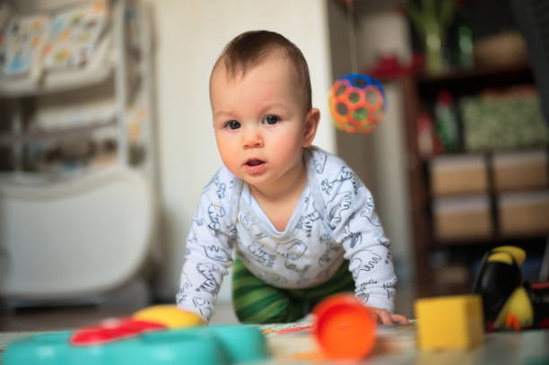 istock Baby boy playing on the floor 1557213937