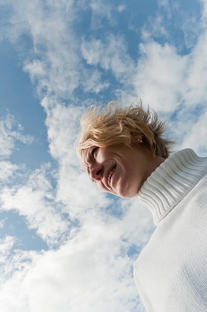 istock Blond woman with cloudy skies background 155724700