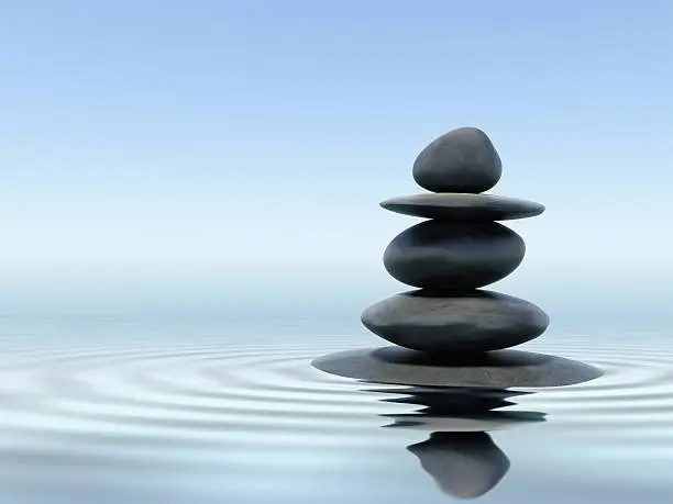 Zen stones in water with reflection
