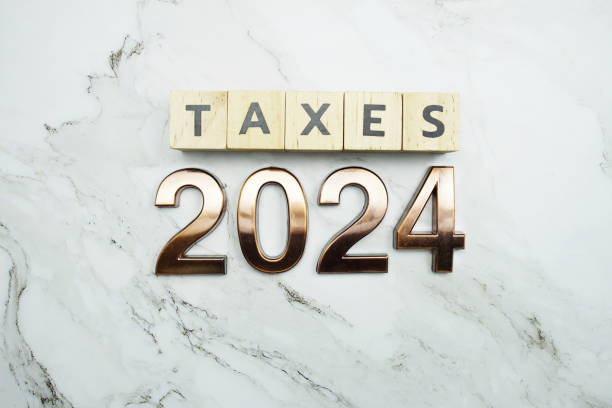 istock Taxes 2024 alphabet letter on marble background 1557261070