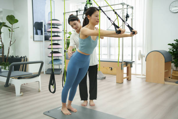 istock Fitness trainer is guiding woman training 1557261250