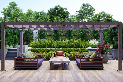 Modern Patio With Armchair, Sofa, Coffee Table And Garden View Background