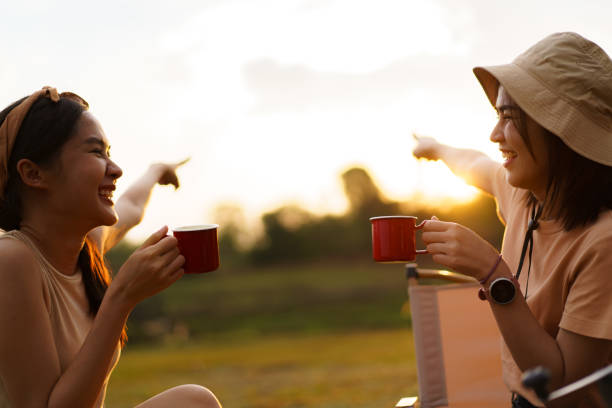 istock Female friends enjoying with camping. 1557265030