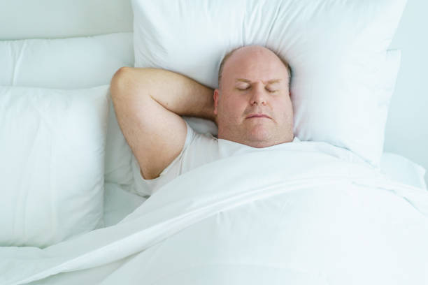 istock Man relaxing in bedroom. 1557265144
