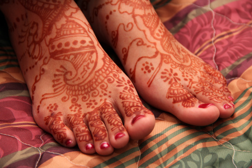 Feet of an Indian bride, covered with henna. Shallow DOF.