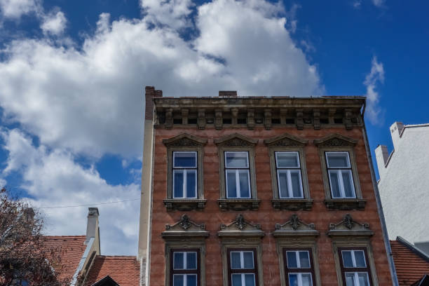 istock fassade from a old building with white clouds in hungary 1557304373