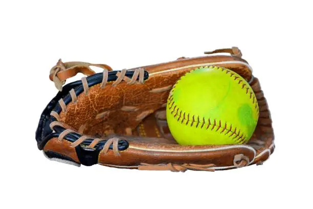 Photo of Closeup Of Vintage Softball Glove And Old ball Isolated On White Background.