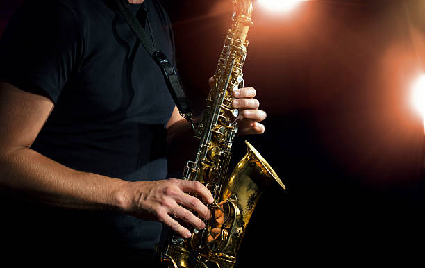 Close-up photo of a person playing a saxophone stock photo