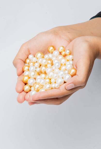 istock Hand of pearls 1557329565