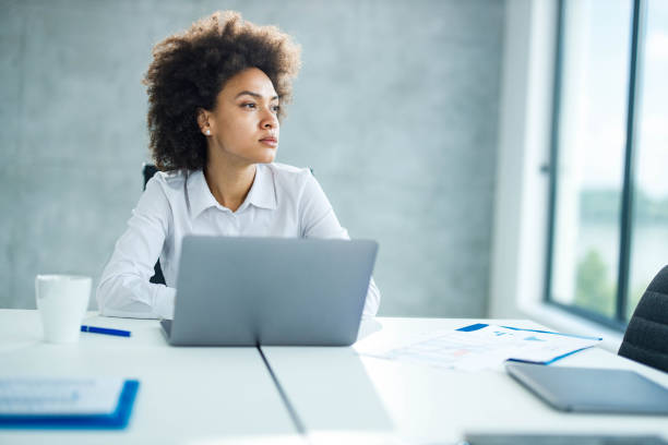 istock Thoughtful black businesswoman working alone in the office. 1557361249