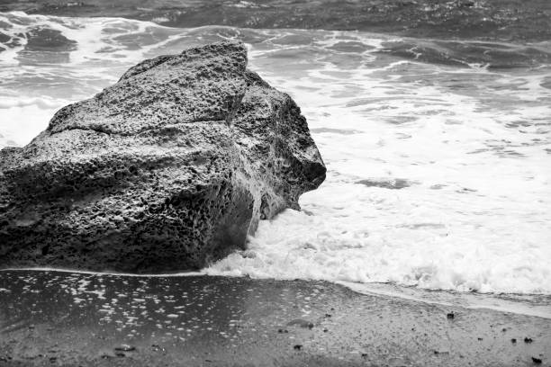 istock Waves crashing rocks on the shore in Los Escullos beach 1557371874