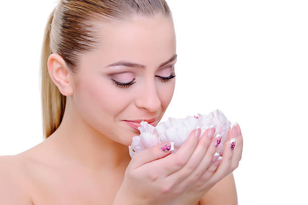 istock woman smelling flower 155737498