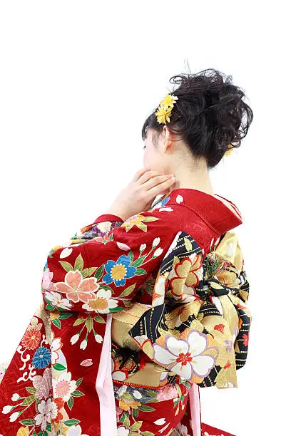 beautiful young girl dressed in traditional Japanese Kimono.