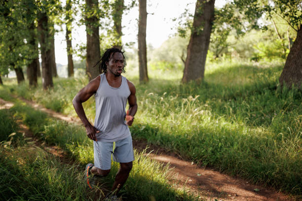 istock Young African man jogging in nature 1557426898