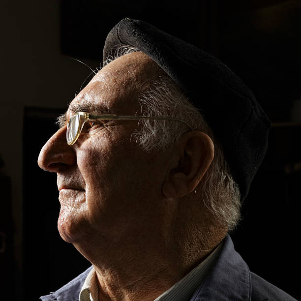 istock Senior in cap and eyeglasses sideview 155743014