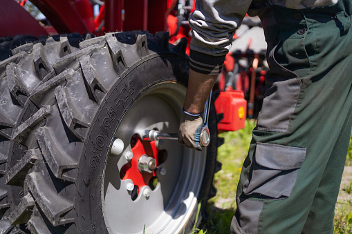 A mechanic repairs agricultural machinery. Modern agricultural machinery and equipment.