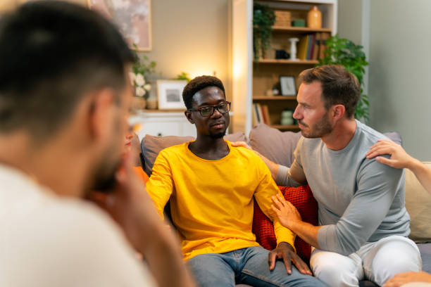 istock Understanding people giving support to depressed crying African man 1557460709