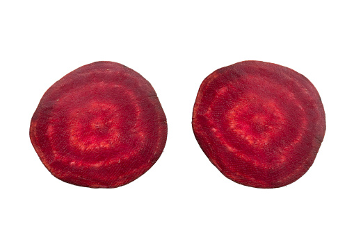 Closeup beetroot (beet root) and cut in half sliced isolated on white background.