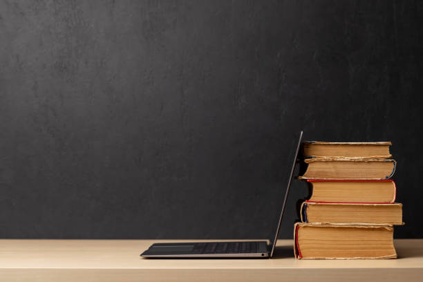 istock Laptop and stack of books 1557461243