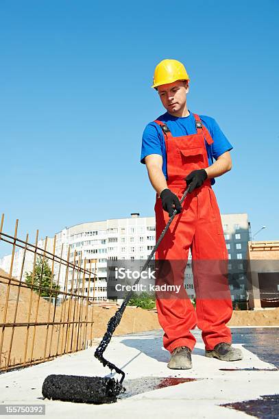 Builder Worker At Roof Insulation Work Stock Photo - Download Image Now - Painting - Activity, Roofer, Adult