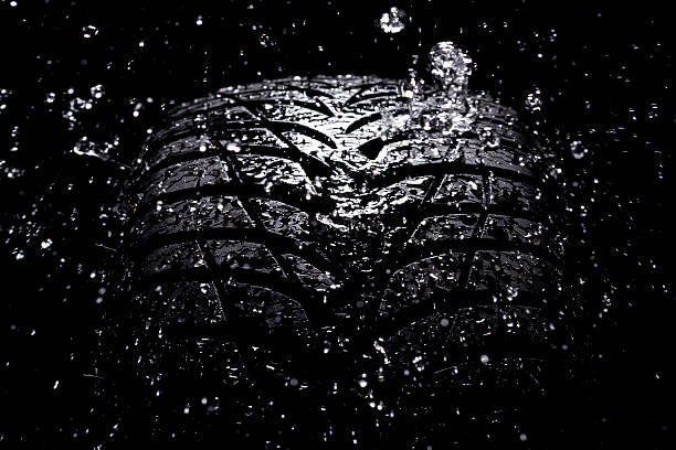 istock Water splashing on a new tire during the rain 155750536