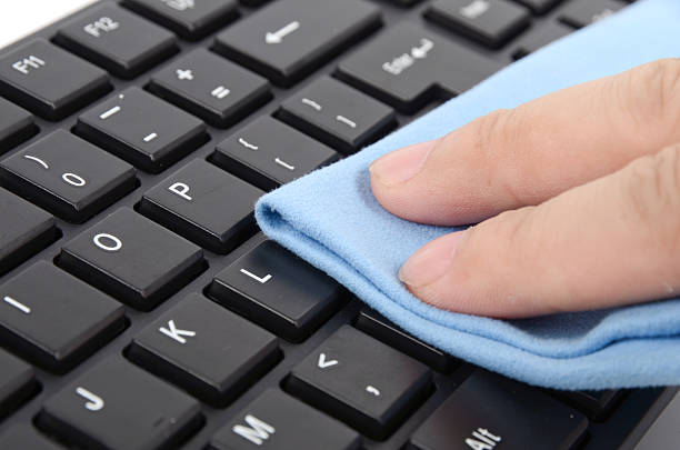 Dusting and cleaning keyboard keys blue cloth and black computer keyboard preening stock pictures, royalty-free photos & images