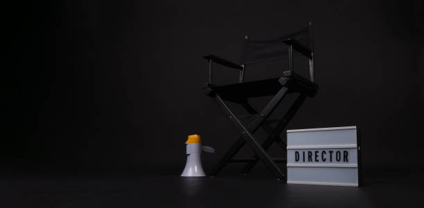 chaise de réalisateur noire et planche à clapet et boîte à lumière et sur fond noir. - lightbox movie camera film photography photos et images de collection