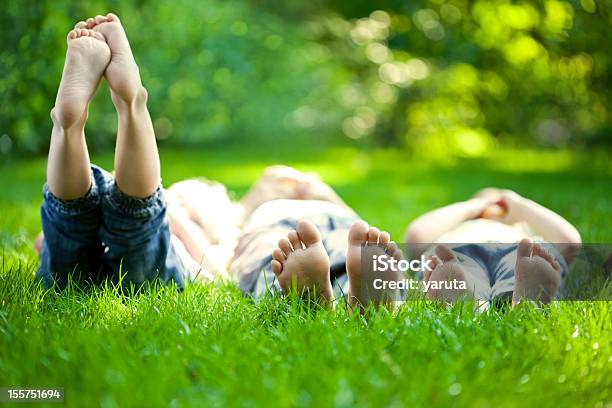 Selective Focus Three Children In Grass At Picnic Stock Photo - Download Image Now - Child, Grass, Family