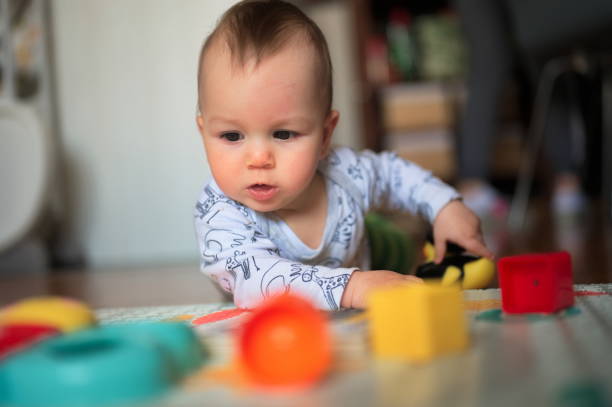 istock Baby boy playing at home 1557530799