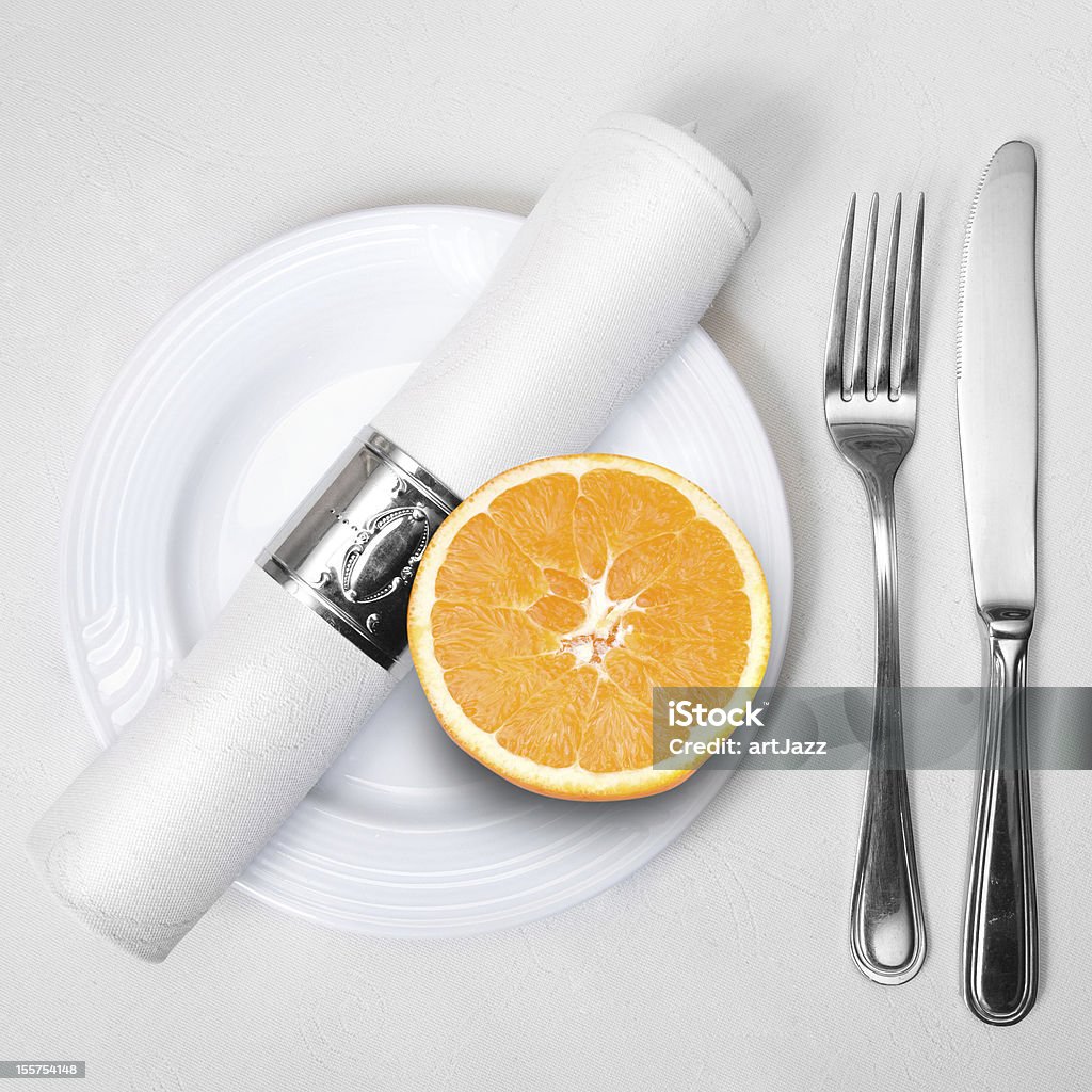 Orange on plate with napkin, fork and knife. Orange on plate with napkin, fork and knife. Healty food. Citrus Fruit Stock Photo